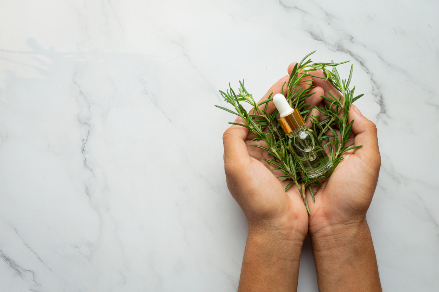 Hands holding a bottle of healing oil.