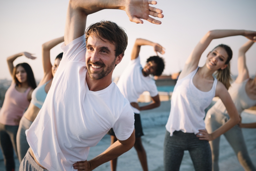 Group of happy people stretching their bodies.