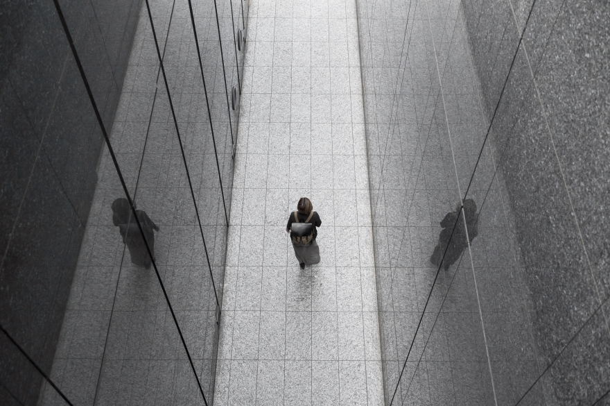 Person walking alone in the shadows, mystified by the dark patterns.