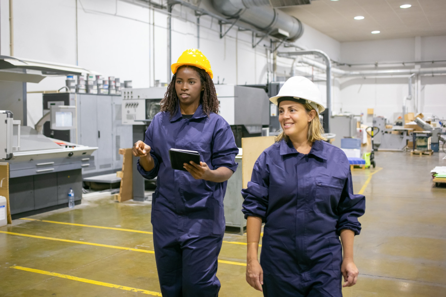 Female engineer collaborating with a colleague on a tech project, representing women in engineering and innovation.